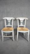 A pair of Empire style distressed painted dining chairs with rush seats on sabre supports. H.89 W.42
