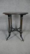 A 19th century ebonised and gilt occasional table on quadruped pedestal base. H.66 D.58cm