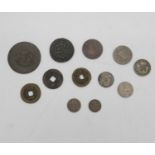 A collection of twelve Oriental coins. Including Chinese and Islamic coins.