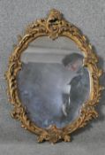 A Rococo style gilt plaster framed wall mirror. H.64 W.48