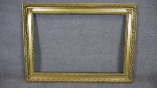 A giltwood and floral gesso decorated picture frame. H74 W115 (H.61 W.91cm internal)