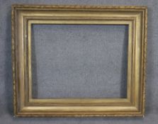 A 19th century gilt wood picture frame with gesso laurel leaf decoration. H107 W125 (H.72 W.93cm