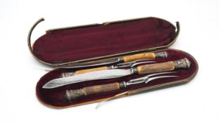 A Victorian silver repousse and deer antler leather and red velvet cased four piece carving set by