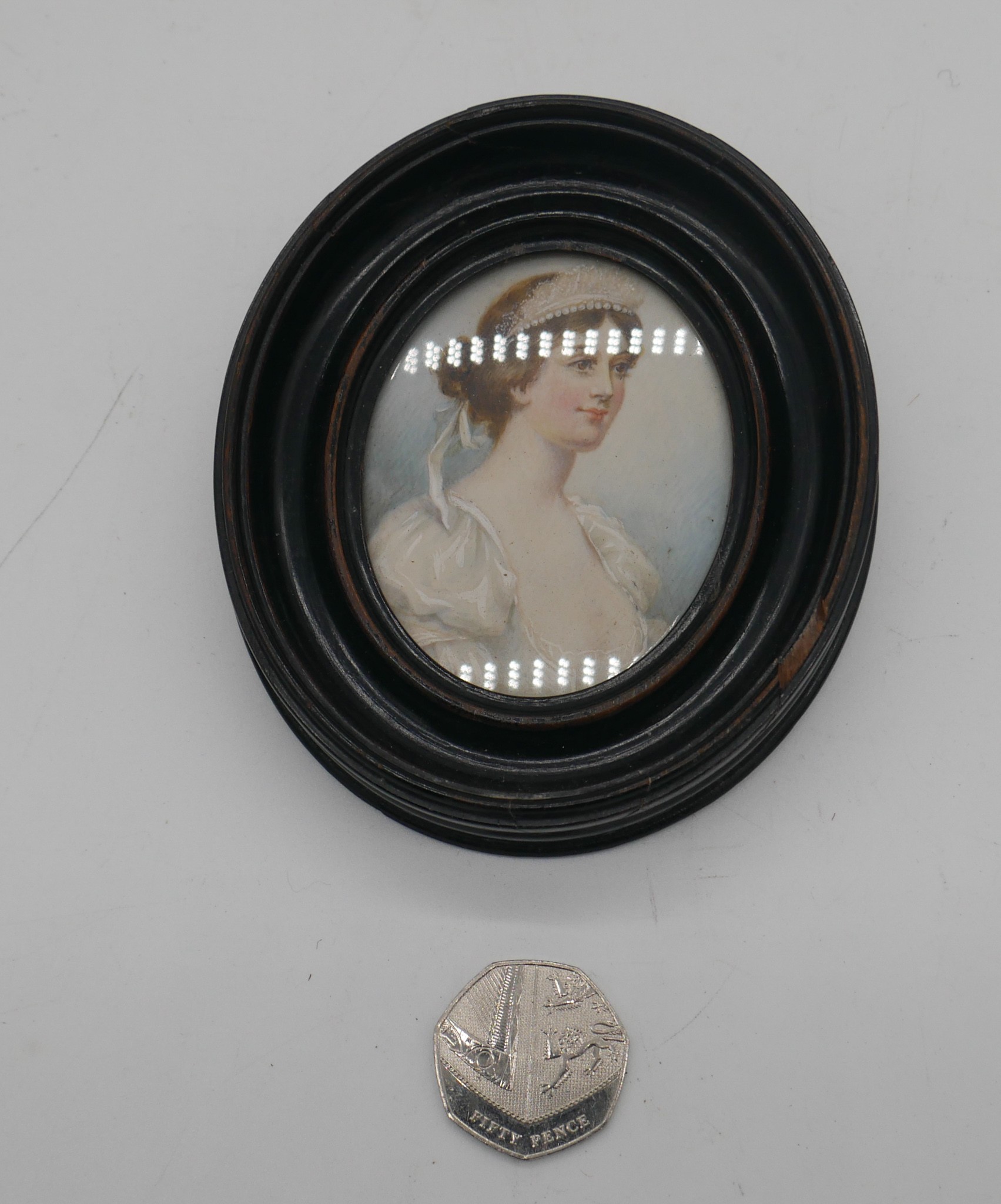 A 19th century ebonised framed and glazed portrait miniature on ivory of a lady in white silk - Image 2 of 3