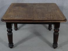 A Victorian mahogany extending dining table on tapering fluted supports. H.64 L.106 W.104cm (no