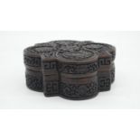 A Chinese moulded resin quatrefoil box. Decorated with flowers and Chinese characters. Impressed