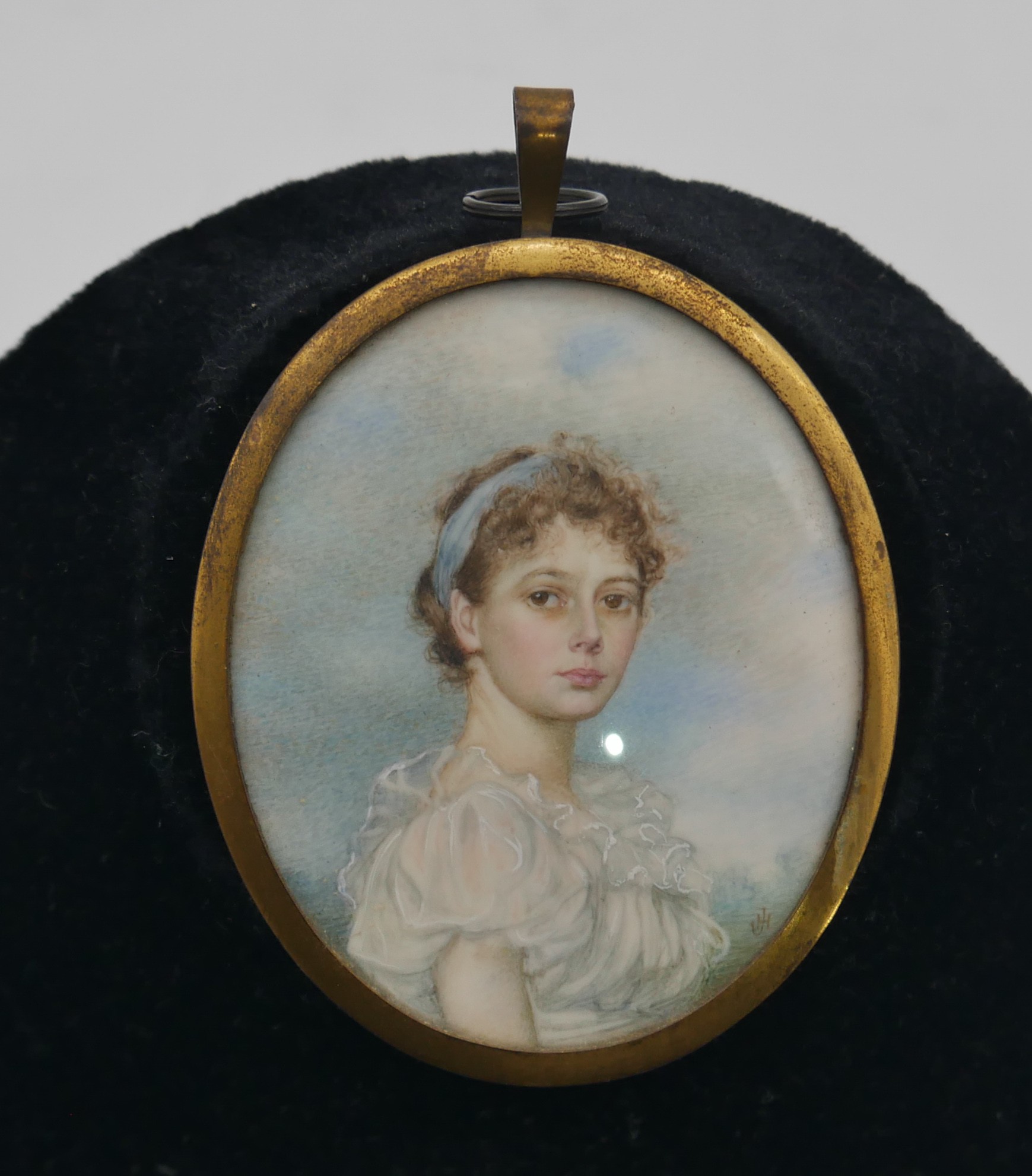 A framed and glazed oval potrait miniature of Beatrice J Hollway by Janet Hollway. Monogrammed JH