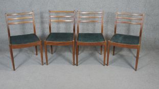 A set of four vintage teak G-Plan dining chairs with maker's label to the underside.