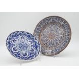 Two Islamic and Greek hand painted plates with a stylised floral design, signed to back. D.31cm