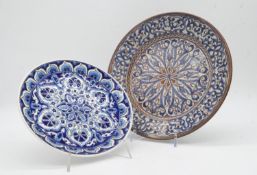 Two Islamic and Greek hand painted plates with a stylised floral design, signed to back. D.31cm