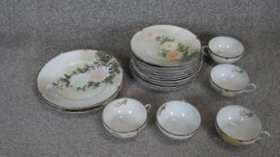 An early 20th century Japanese egg shell hand painted floral design porcelain part tea set. Includes
