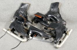 Three pairs of C.1900 black leather ice skates. One with a fold over design and tan leather