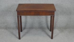 A Georgian mahogany foldover top tea table with gateleg action on square supports. H.71 W.81 D.40