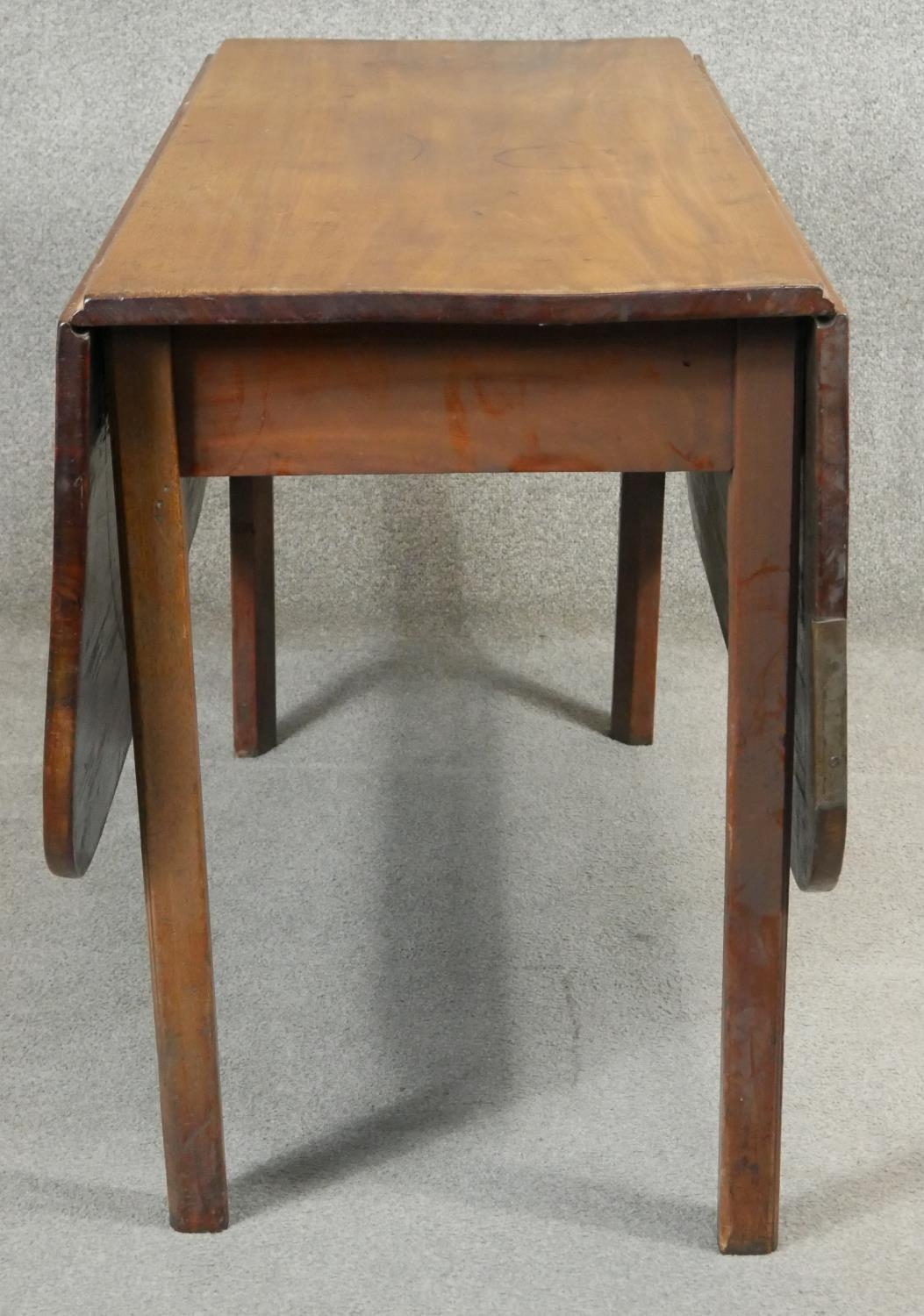 A Georgian mahogany drop flap dining table with gate leg action on square section supports. H.72 L. - Image 6 of 6