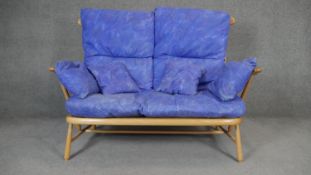 A vintage beech Ercol Evergreen two seater sofa. H.100 W.144 D.75cm