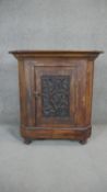 An Eastern carved teak floor standing corner cabinet. H.93 W.87 D.54cm