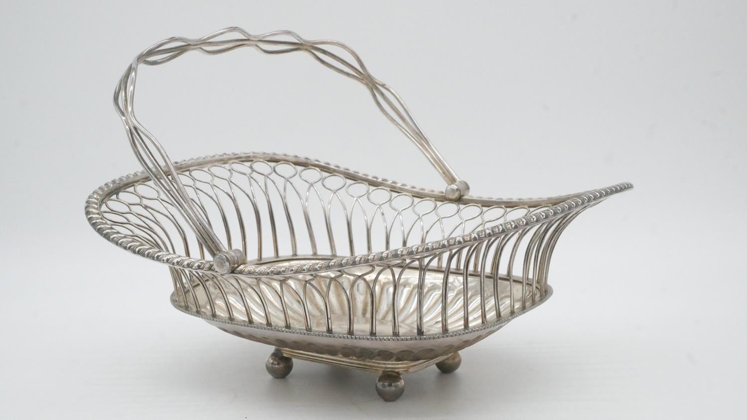 A collection of silver plate. Including a swing handled pierced basket, two C-scroll handled gravy - Image 4 of 9