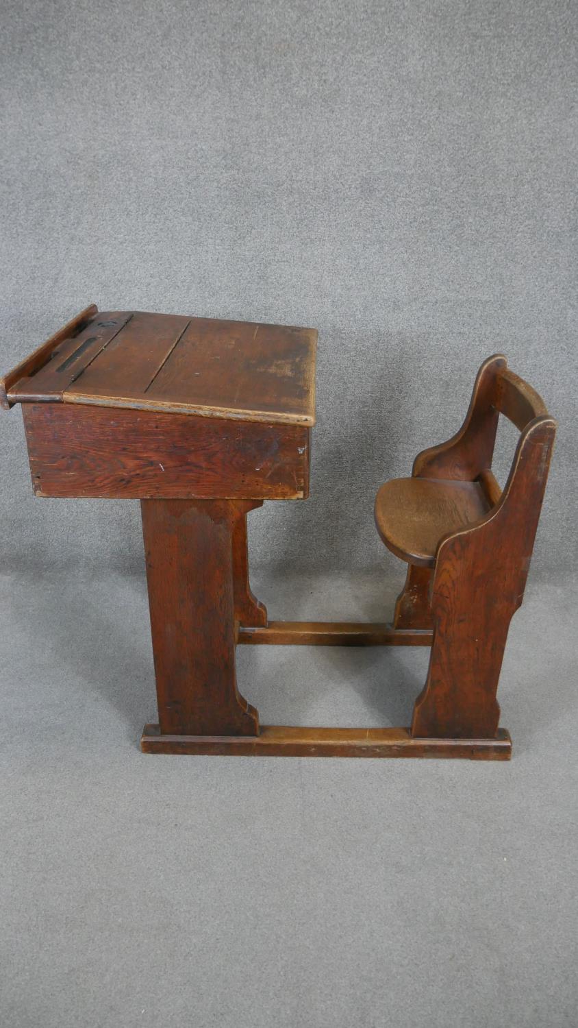 A vintage oak school desk with integral bench seat. H.88 W.90 D.69cm - Image 4 of 4