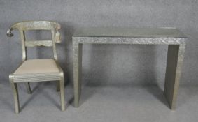 An Eastern style embossed metal clad console table and a similar bar back dining chair on sabre