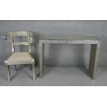 An Eastern style embossed metal clad console table and a similar bar back dining chair on sabre