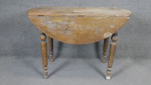 A late 19th century French pine drop flap dining table on fluted tapering supports. H74 W110 D56,