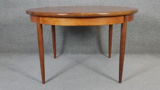 A vintage teak G-Plan dining table with integral fold out leaf fitted to the underside. H.74 W.122