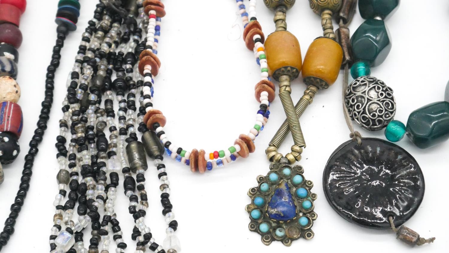 A collection of costume jewellery. Inluding a tribal cane glass bead necklace and other necklaces. - Image 4 of 6