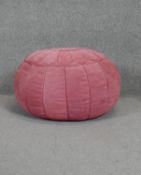 A vintage blush pink suede Moroccan style pouffe.