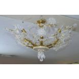 A gilt metal ceiling chandelier with crystal floral decoration on naturalistic branches. D.70cm