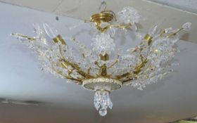 A gilt metal ceiling chandelier with crystal floral decoration on naturalistic branches. D.70cm