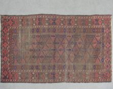 A Persian Belouch rug with repeating diamond design on a madder field within multiple borders. L.157