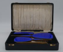 A leather effect cased Art Deco engine decorated cobalt blue enamel on silver deposit four piece