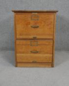 A C.1900 oak two drawer filing chest with maker's label and original brassware. H.70 W.54 D.74cm