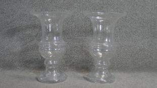 A pair of large glass campana form vases.