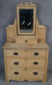A 19th century pine dressing table with swing mirror and bijouterie drawer on shaped supports.
