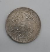 A 1909 Hong Kong silver trading dollar in capsule case with COA. 28g.