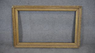 A gilt wood and floral gesso decorated picture frame. H80 W110 (H.57 W.100cm internal)