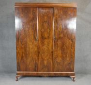 A mid century quarter veneered figured walnut double wardrobe on squat cabriole supports. H.204 W154