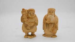 Six Japnese early 20th century ivory netsukes of deities with a cedar and silver plate cigarette