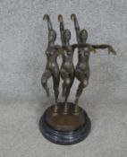 An Art Deco style bronze figure group, three female swimmers in a pose, mounted on a black veined