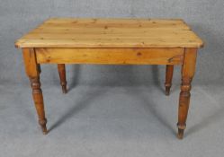 A Victorian pine kitchen table with end cutlery drawer on turned tapering supports. H74 W120 D80cm