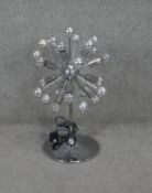 A vintage chrome Sputnik table lamp with chrome circular base.