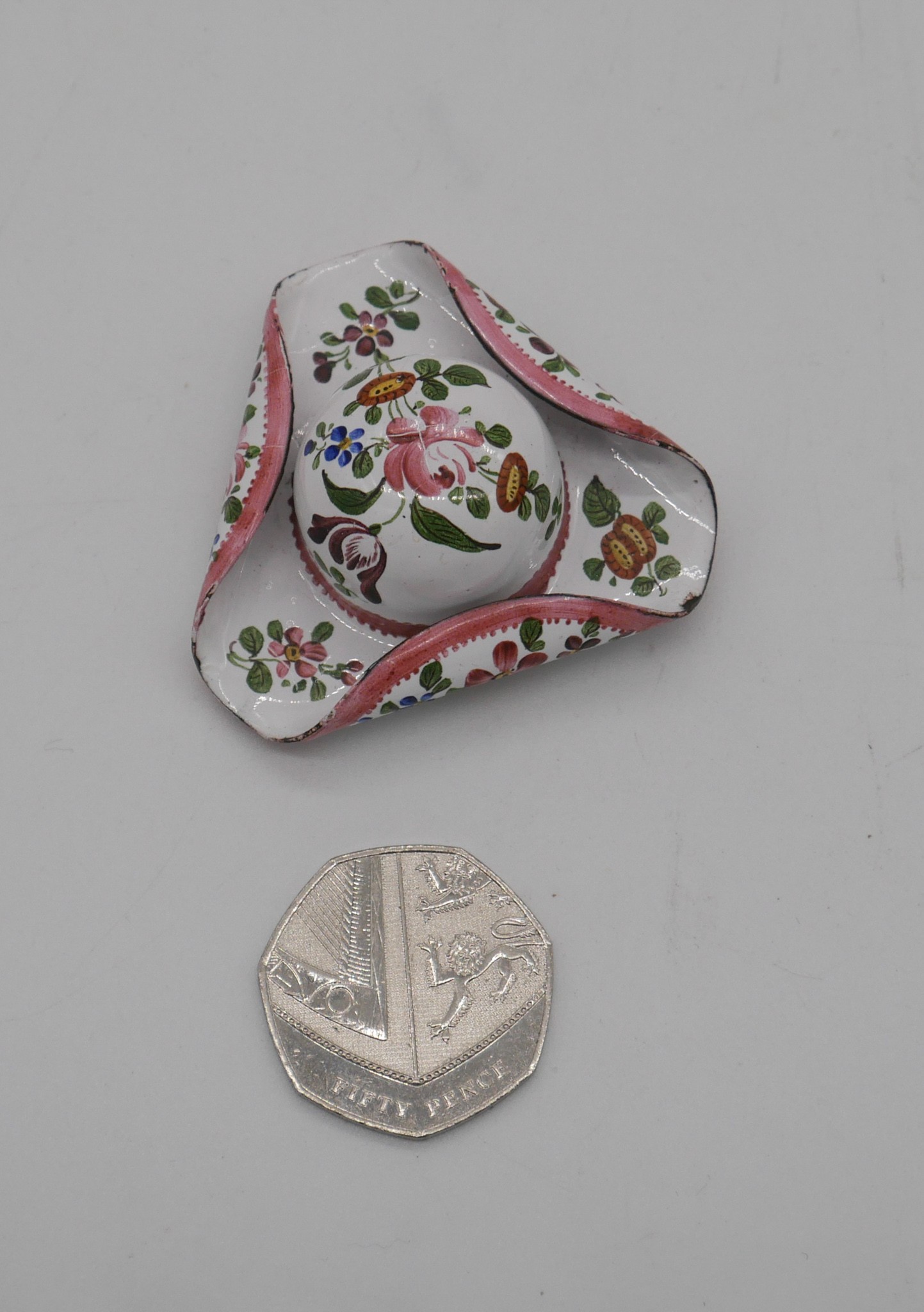 A late 19th century enamel patch box in the form of a tricorn hat, the white ground decorated with - Image 2 of 3