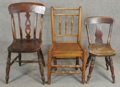 A 19th century elm spindle back hall chair and two 19th century kitchen chairs. H.92cm