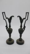 A pair of bronze handled urn form candle sticks on balck marble bases. H.30cm