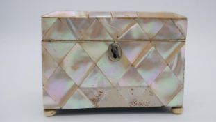 A 19th century mother of pearl mosaic tea caddy on ivory bun feet. (some pieces missing, others