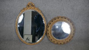 A mid century gilt mirror with scrolling ribbon cresting and a similar smaller circular mirror. H.63