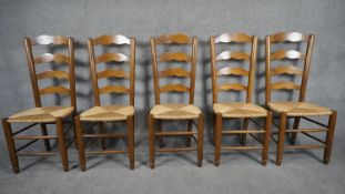 A set of five antique style country ladder back dining chairs with rush seats on stretchered