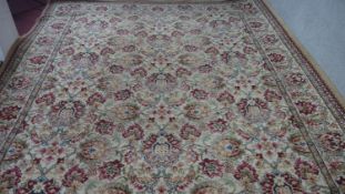 A woollen carpet with all over scrolling lotus flower decoration on a fawn ground. 360x270cm