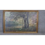 A gilt framed oil on canvas, trees by a lake, signed H. Delfs Kiel. H.80 W.120cm